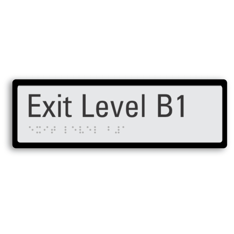 exit level B1 (basement 1) signage with braille tactile elements and black border for enhanced contrast