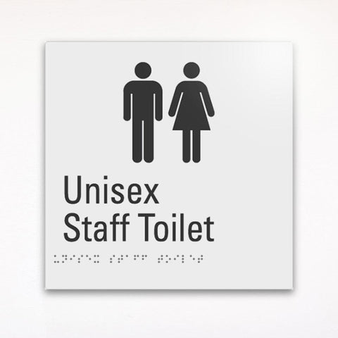 a gray braille toilet sign saying unisex staff toilet