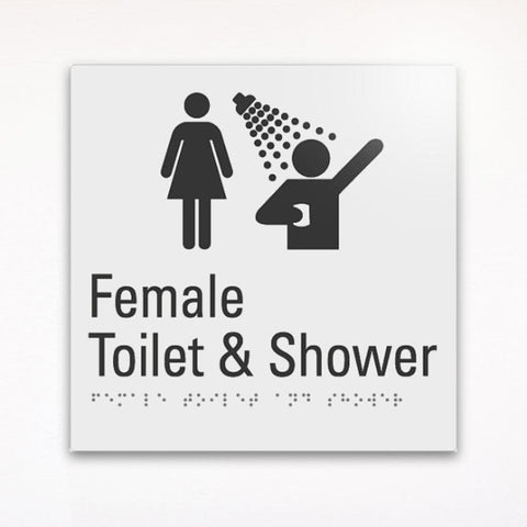 a gray braille toilet sign saying Female Toilet and Shower