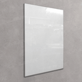 A large, blank white rectangular mirror with a slim silver frame, mounted on a textured gray concrete wall.