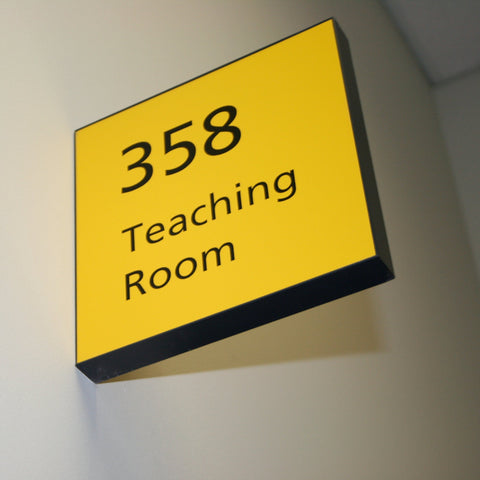 a yellow projecting sign with "358 teaching room" wording