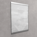 A vertical rectangular glass or acrylic display panel with a slim metallic frame, mounted on a textured gray wall. The panel is shown empty and slightly reflective, with faint interior room reflections visible.
