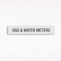 a gray Gas & Water Meters sign